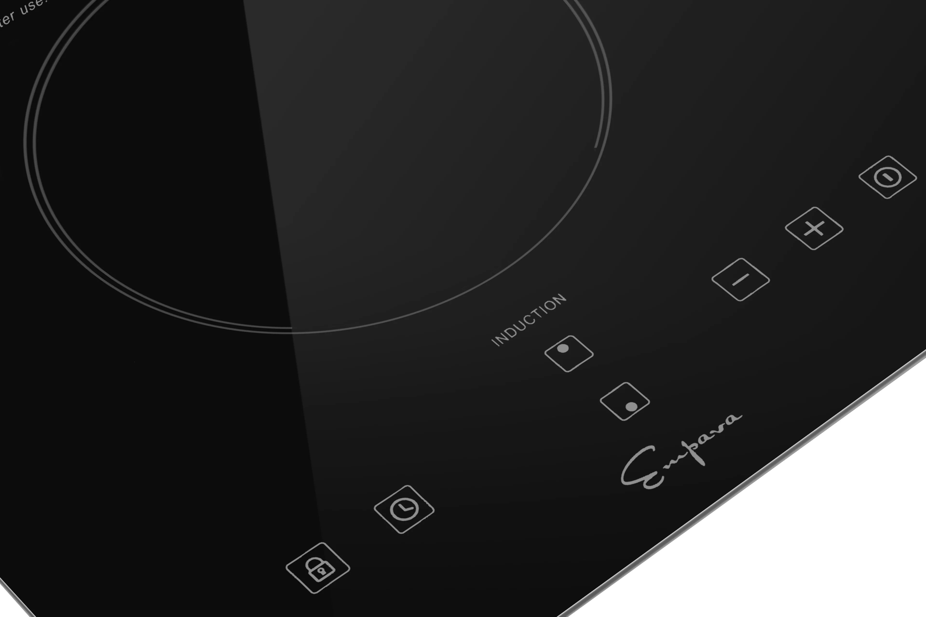 Black induction cooktop glass with touch control icons near the right burner zone