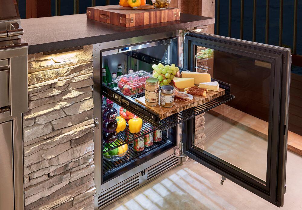 Compact refrigerator with open glass door showing shelves with groceries and drinks