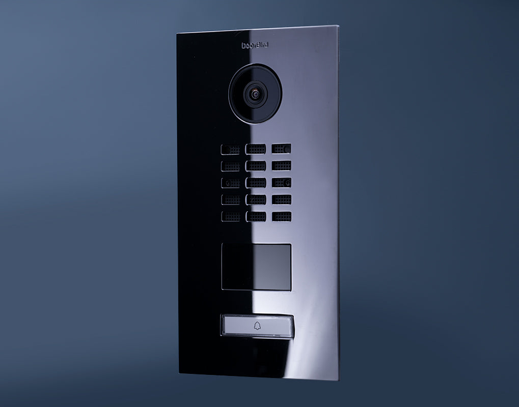 DoorBird video door station with circular camera, keypad, and call button module