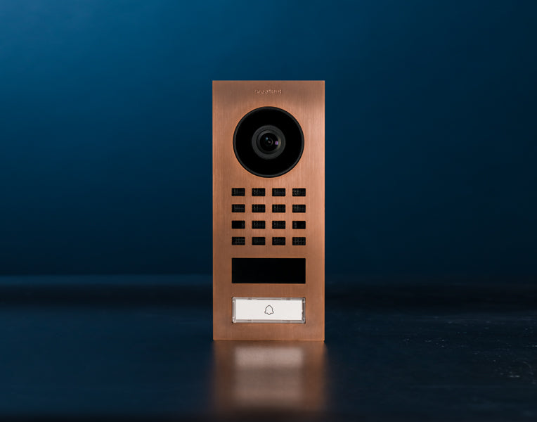 Bronze DoorBird video door intercom panel with camera, keypad, and call button