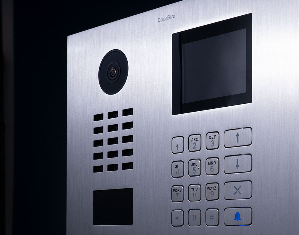 Stainless steel DoorBird video door station front panel with camera, screen, and number keypad