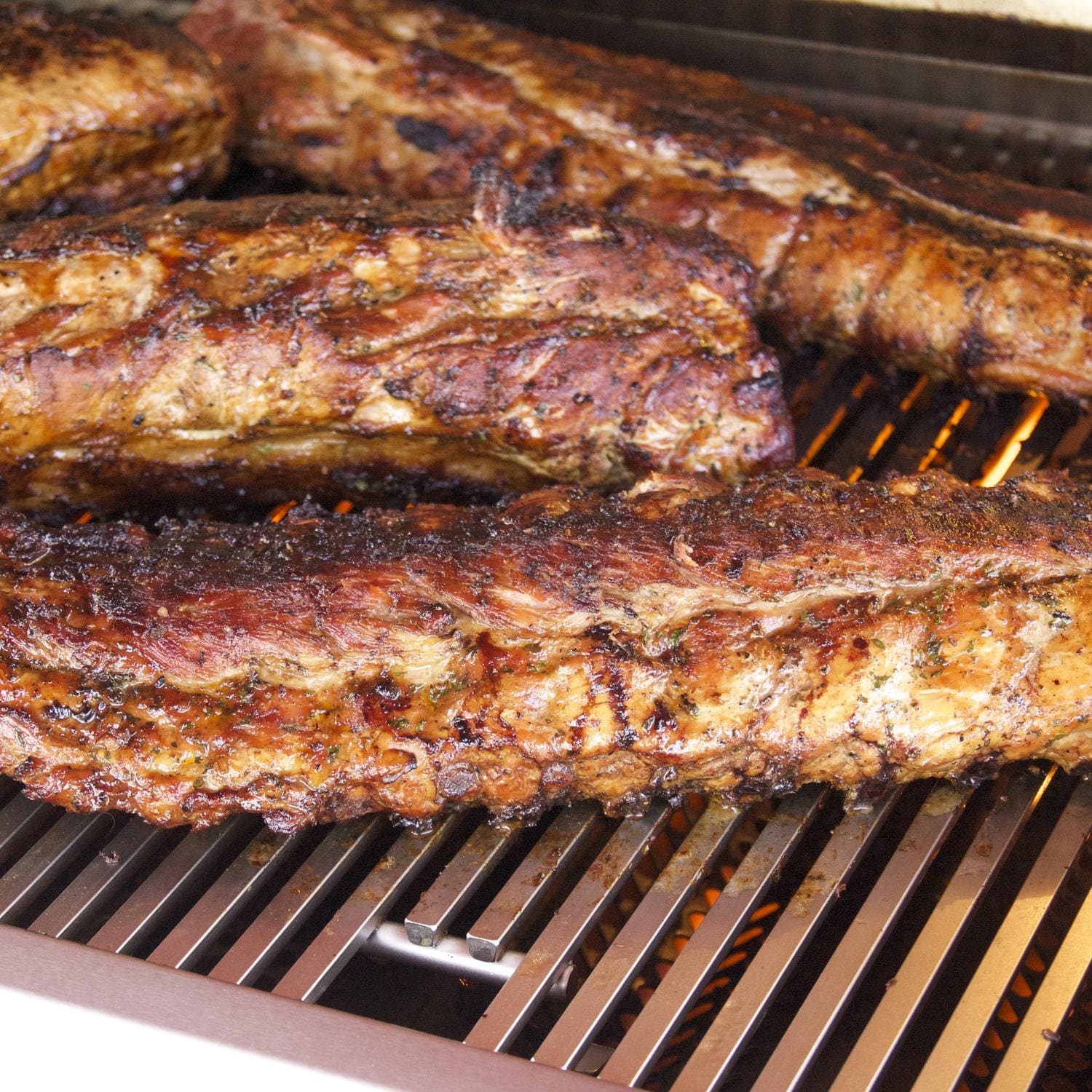 Grilled chicken on stainless cooking grates with seared surface