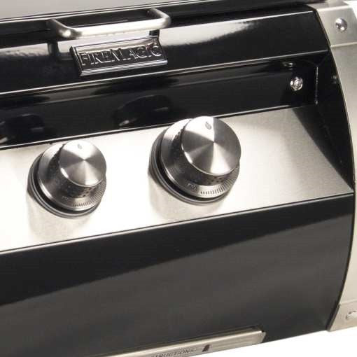 Built-in power burner for grill with two stainless control knobs on black panel