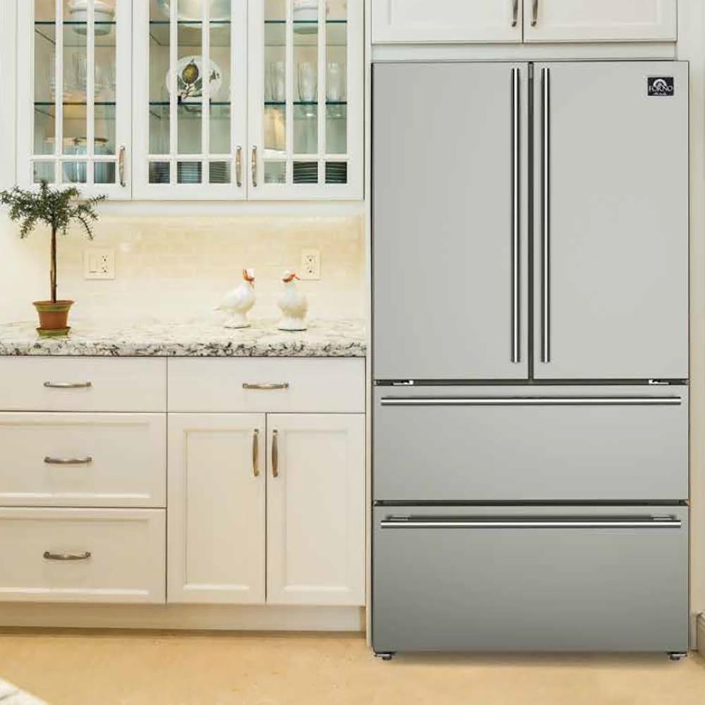 Stainless steel top-freezer refrigerator with vertical handles, installed in a kitchen