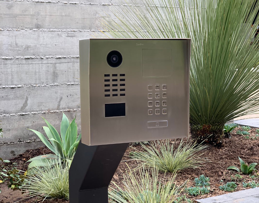 Stainless steel IP video door station outdoors with camera lens and numeric keypad