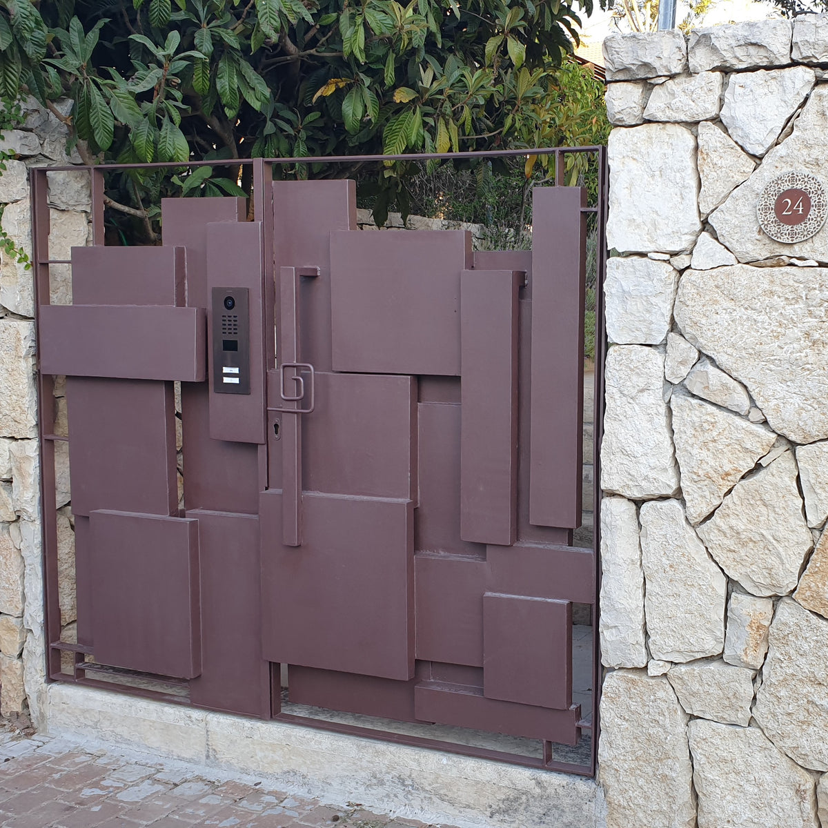 Bronze outdoor video door station on gate with camera and keypad panels