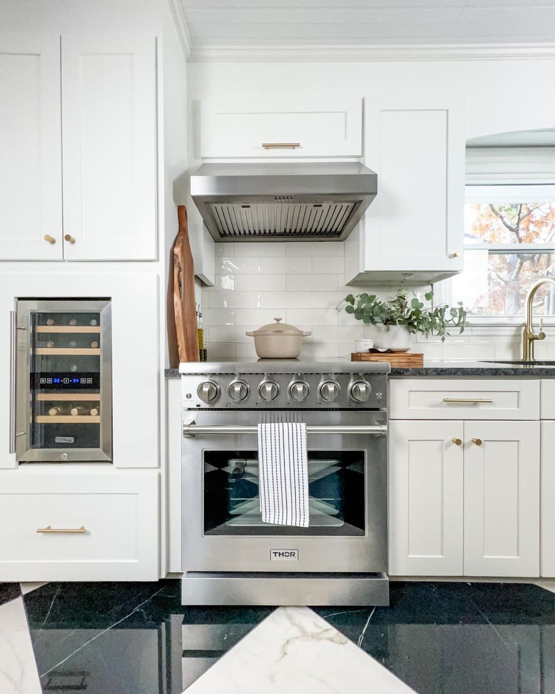Stainless steel electric range with cooktop burners, oven window, and hood.