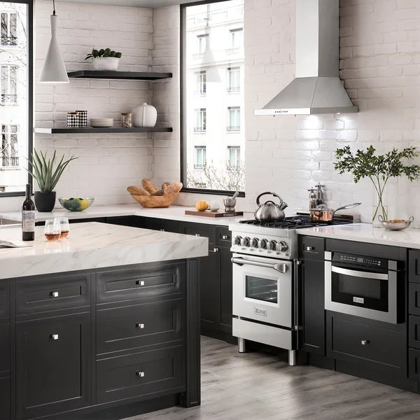 White wall-mounted range hood over cooktop with front baffle filters