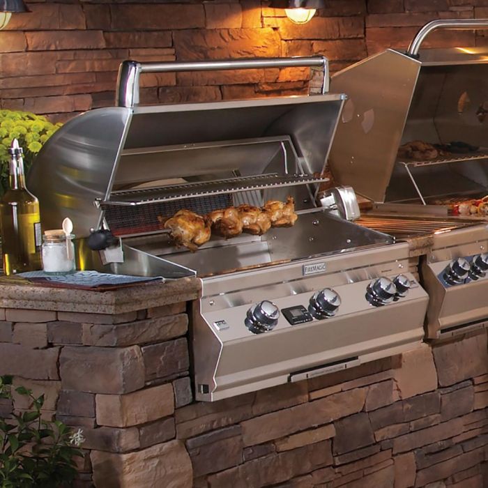Heavy-duty rotisserie kit installed on stainless gas grill, spit and skewer area