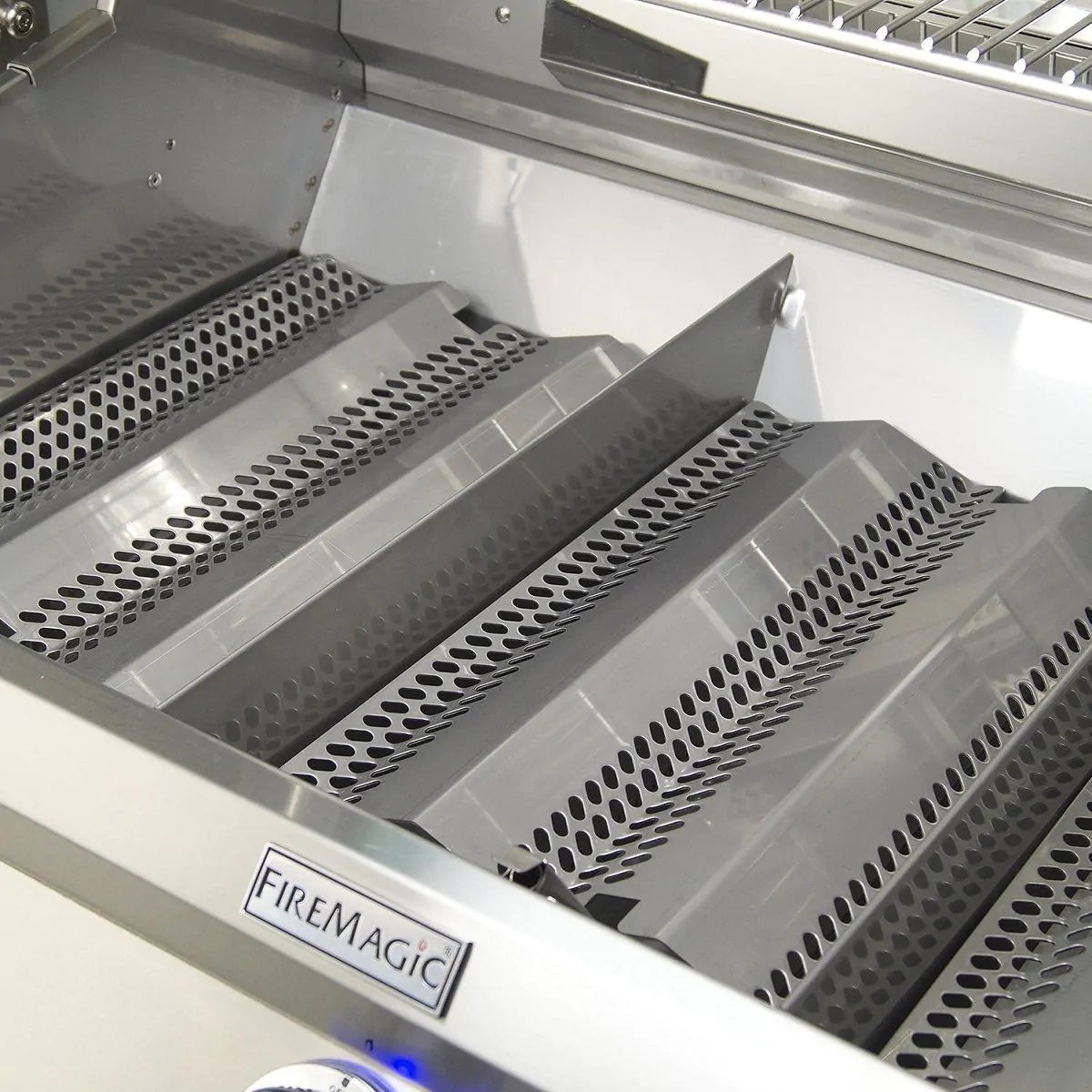 Stainless grill firebox with perforated warming grids and interior side panels