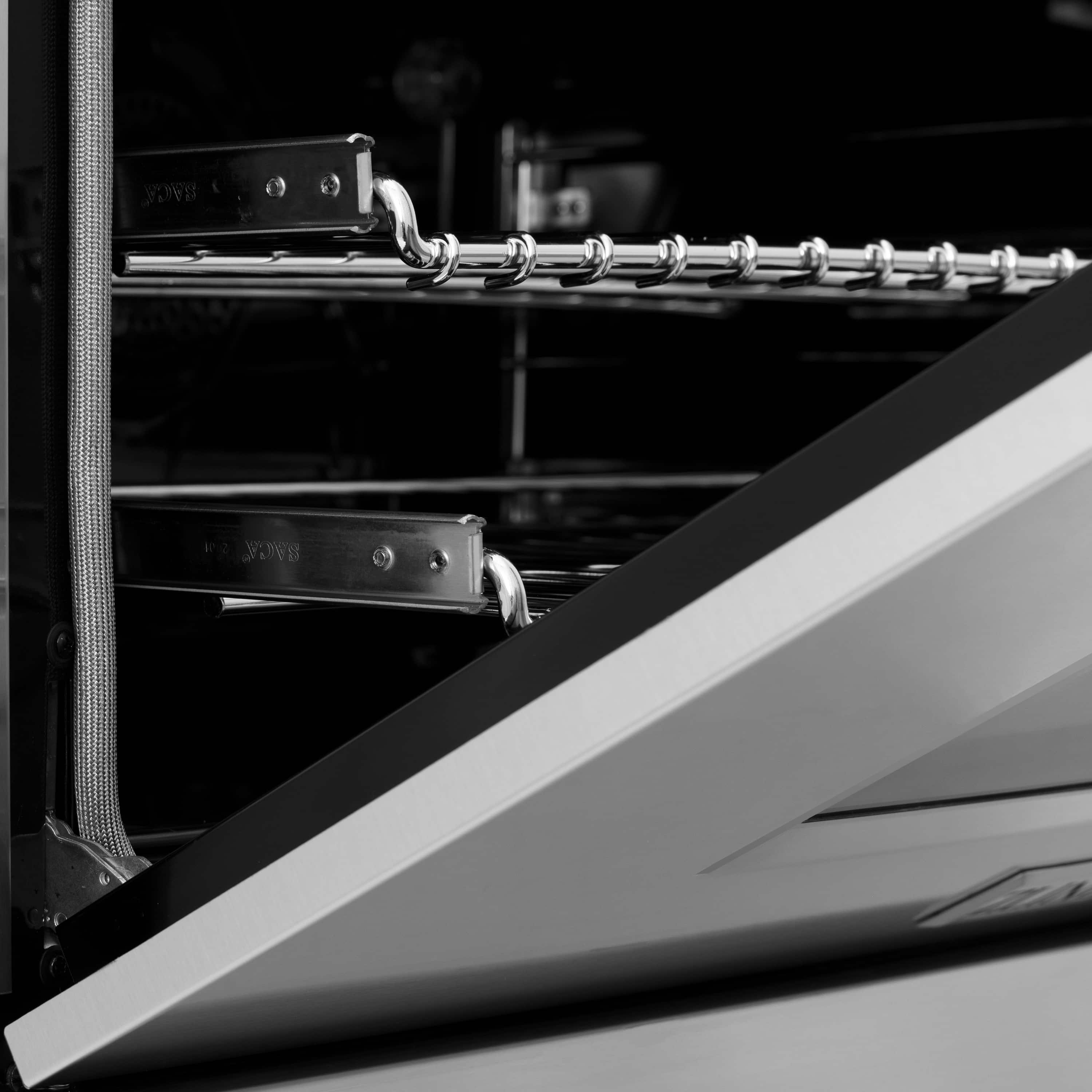 Stainless steel oven cavity with cooking rack rails and burner components close-up