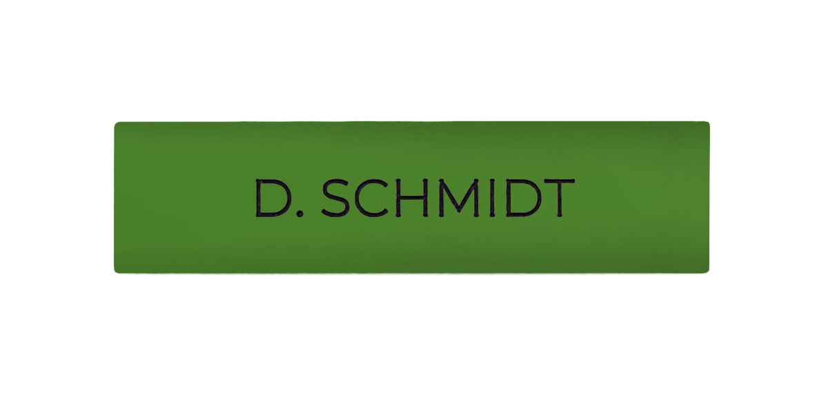 Yellow-green engraved nameplate with text 'D. SCHMIDT'