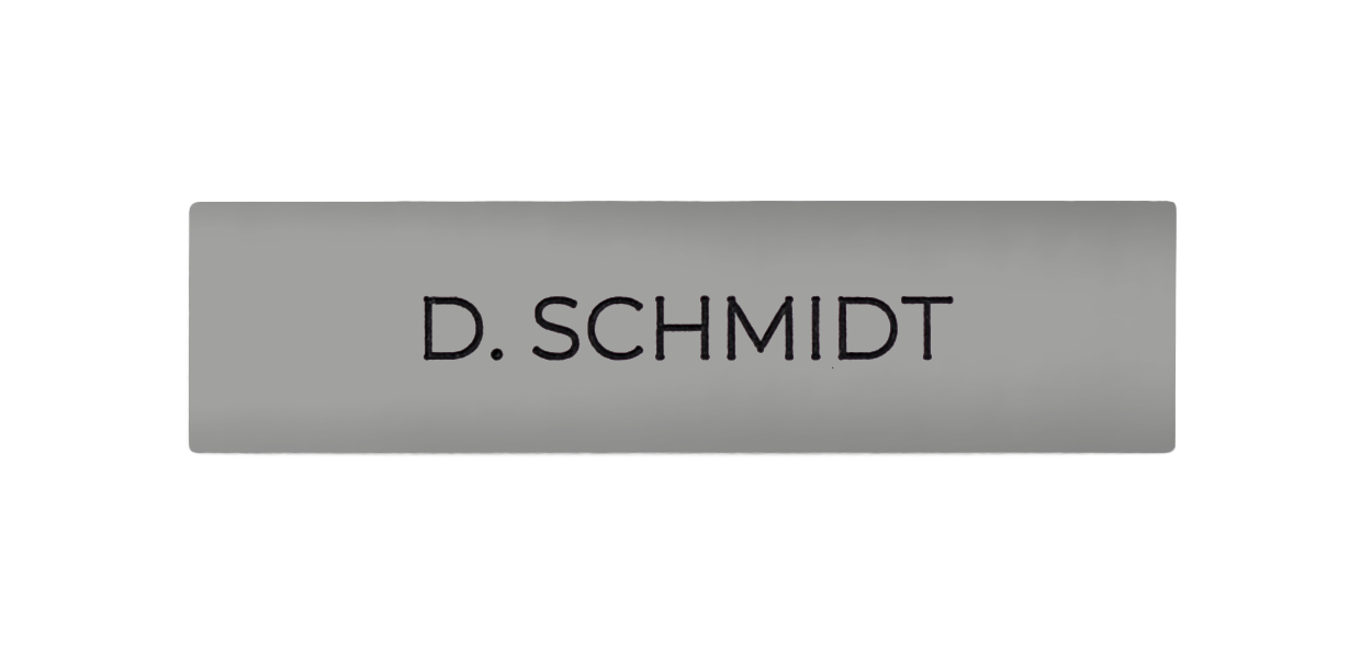 White aluminum nameplate with engraved "D. SCHMIDT" text
