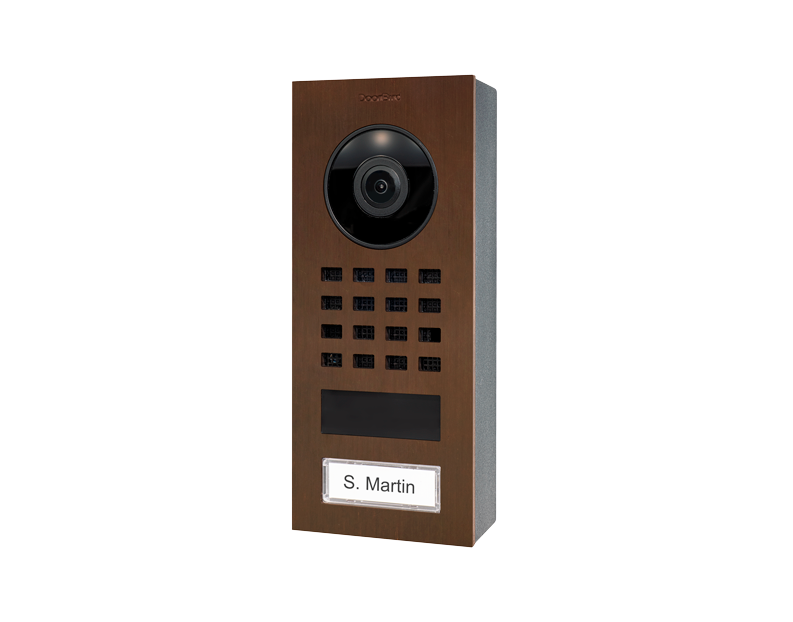 Architectural bronze video door intercom with camera lens, keypad grid, and nameplate