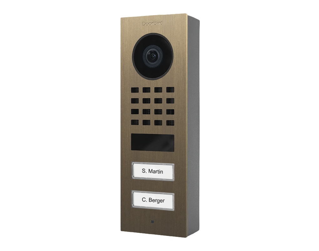 DoorBird burnished brass surface-mount video door station with camera, speaker grille, 2 call buttons