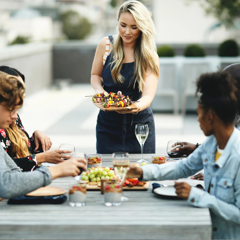 Outdoor meal with propane grill in use, showing gas hookup accessory connection