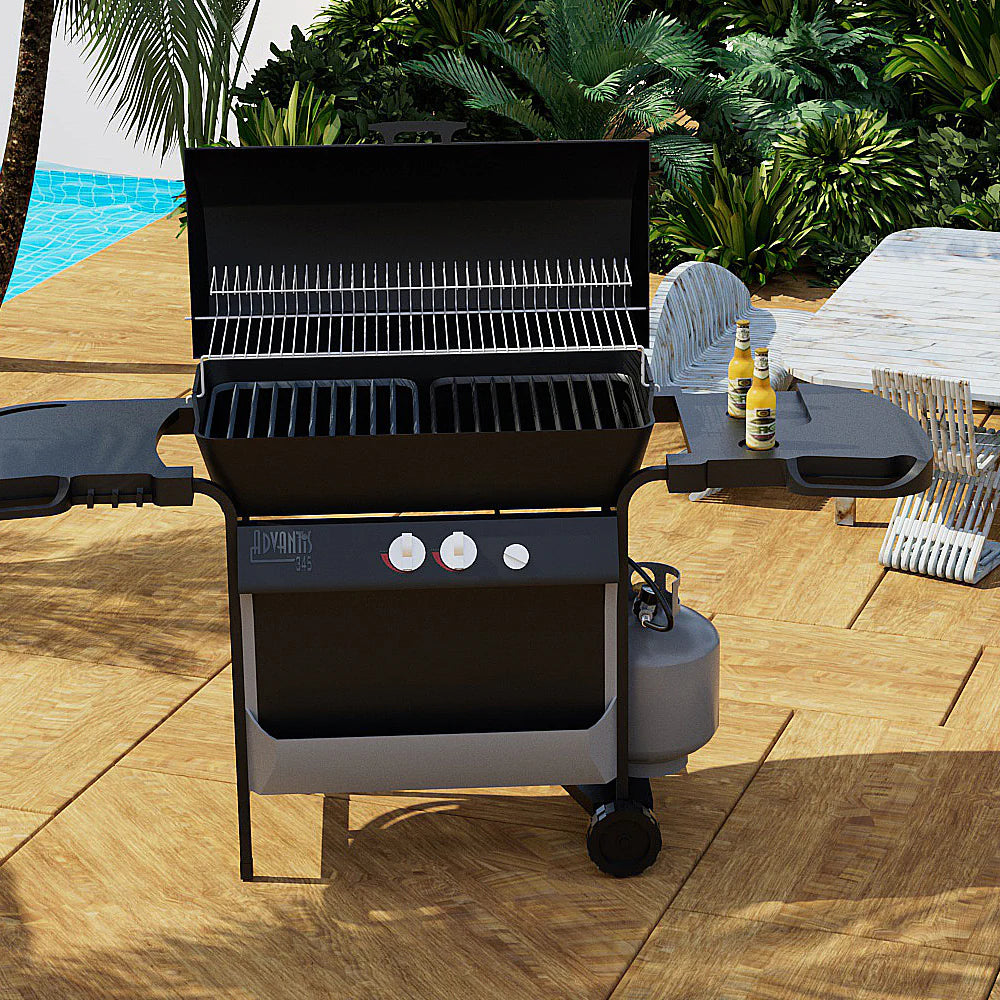 Outdoor black propane grill with connected gas hose and valve assembly near burner