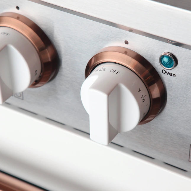 Stainless dual fuel range control panel with copper knobs labeled Off and Oven