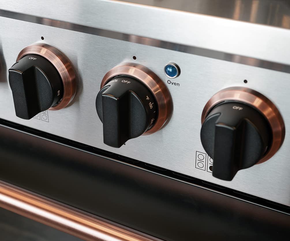 Stainless gas range control panel with three rose-gold knob accents