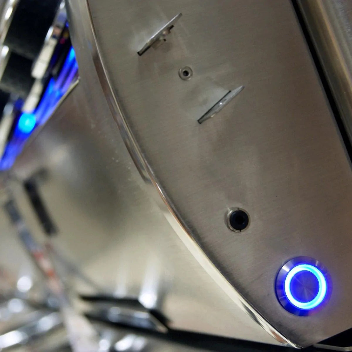 Stainless control panel with blue-lit knob on built-in gas grill