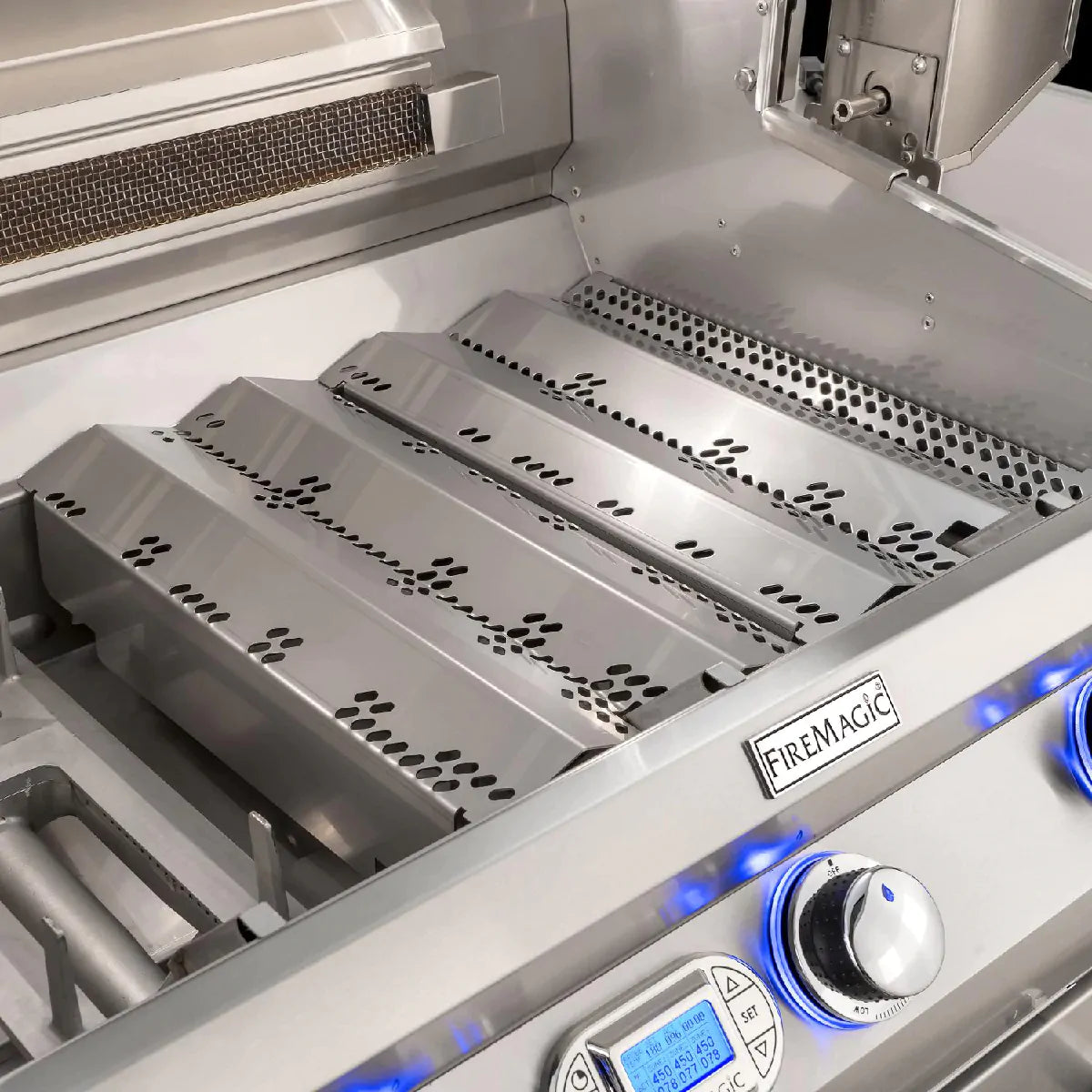 Built-in grill firebox with stainless steel burners and blue gas ignition flames