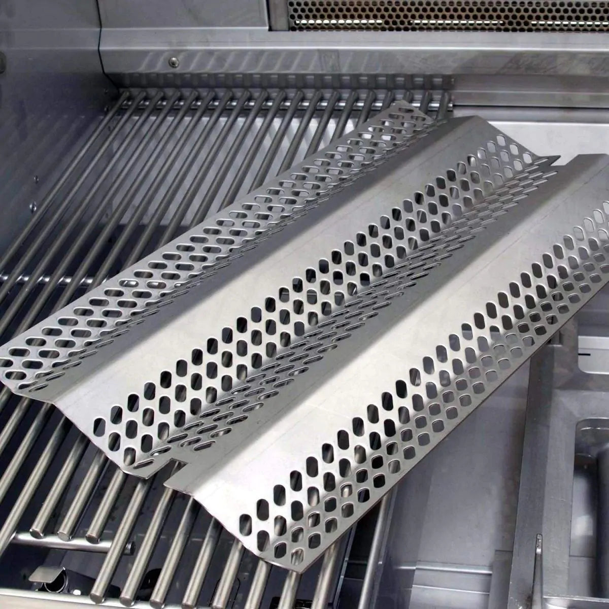 Perforated stainless steel heat zone dividers over grill grates