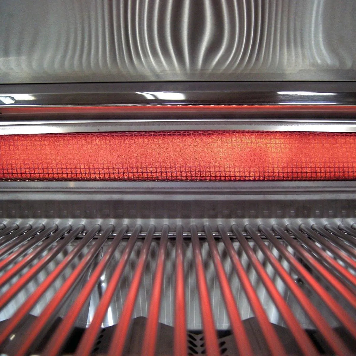 Built-in propane grill cooking grates with red-orange heat glow and stainless bars
