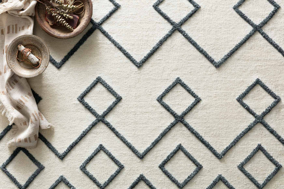 Ivory hand-woven rug with textured look and navy diamond pattern
