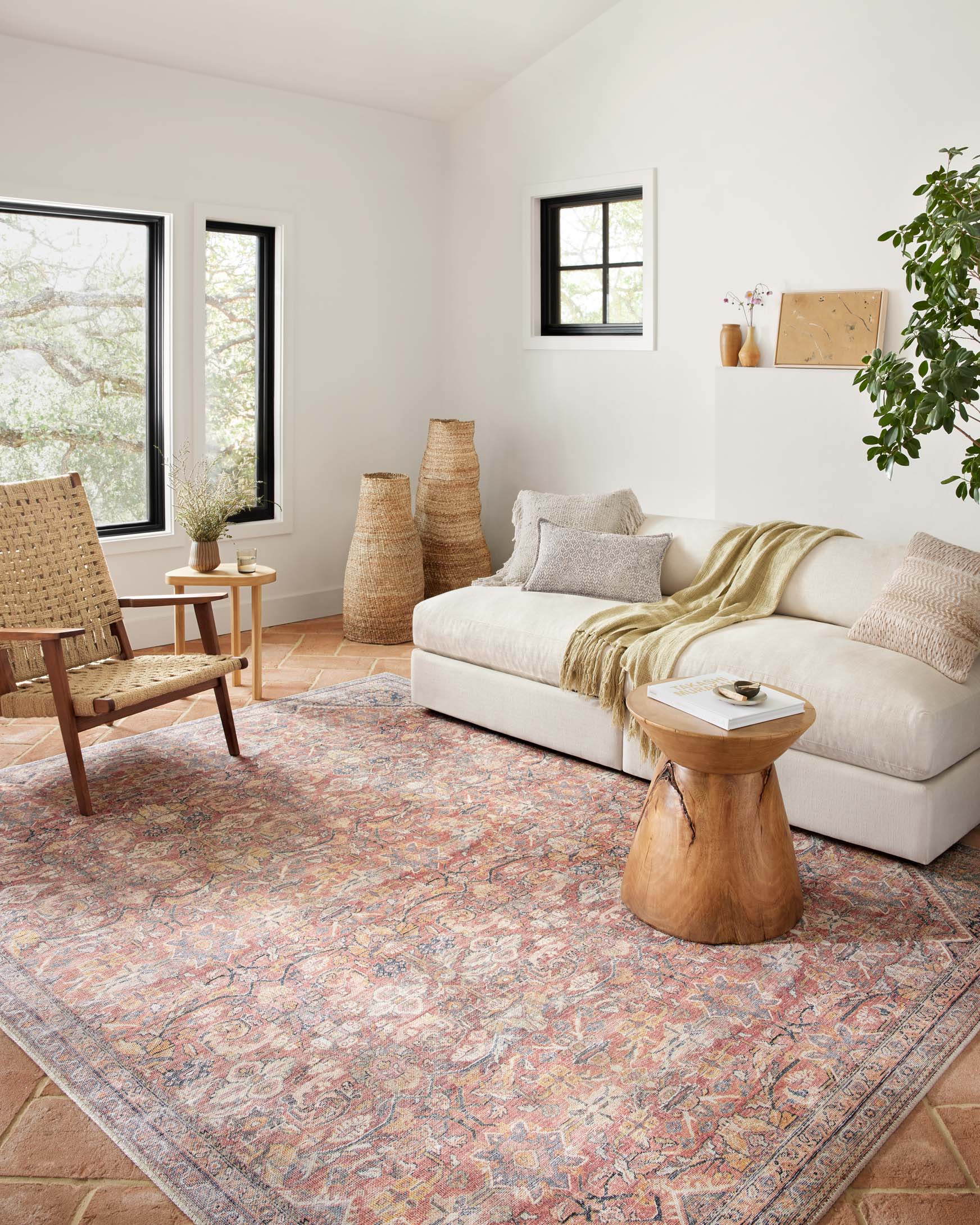 Traditional power-loomed rug with vintage medallion motif in rust and denim tones.