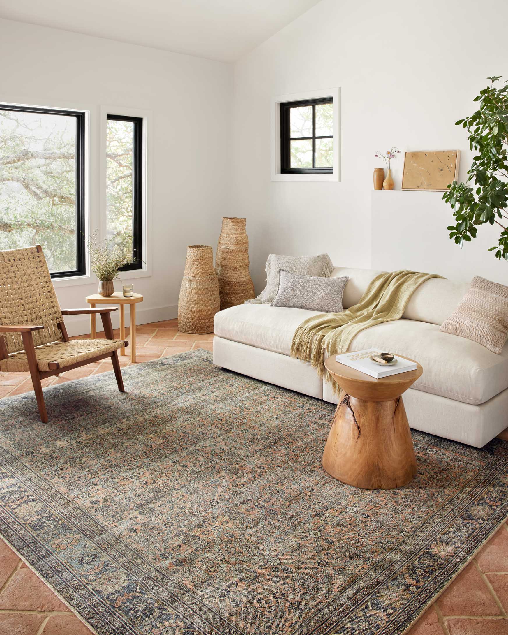 Ornate multicolor area rug in a bright room, traditional design with terracotta and blue