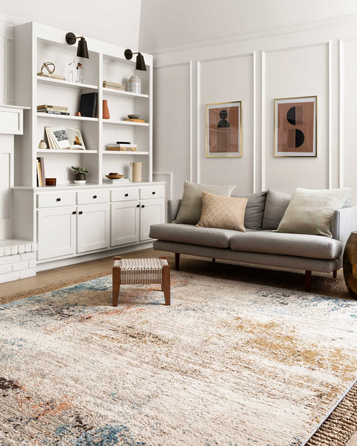 Abstract ivory rug with varied blue and orange speckled details and subtle gray lines