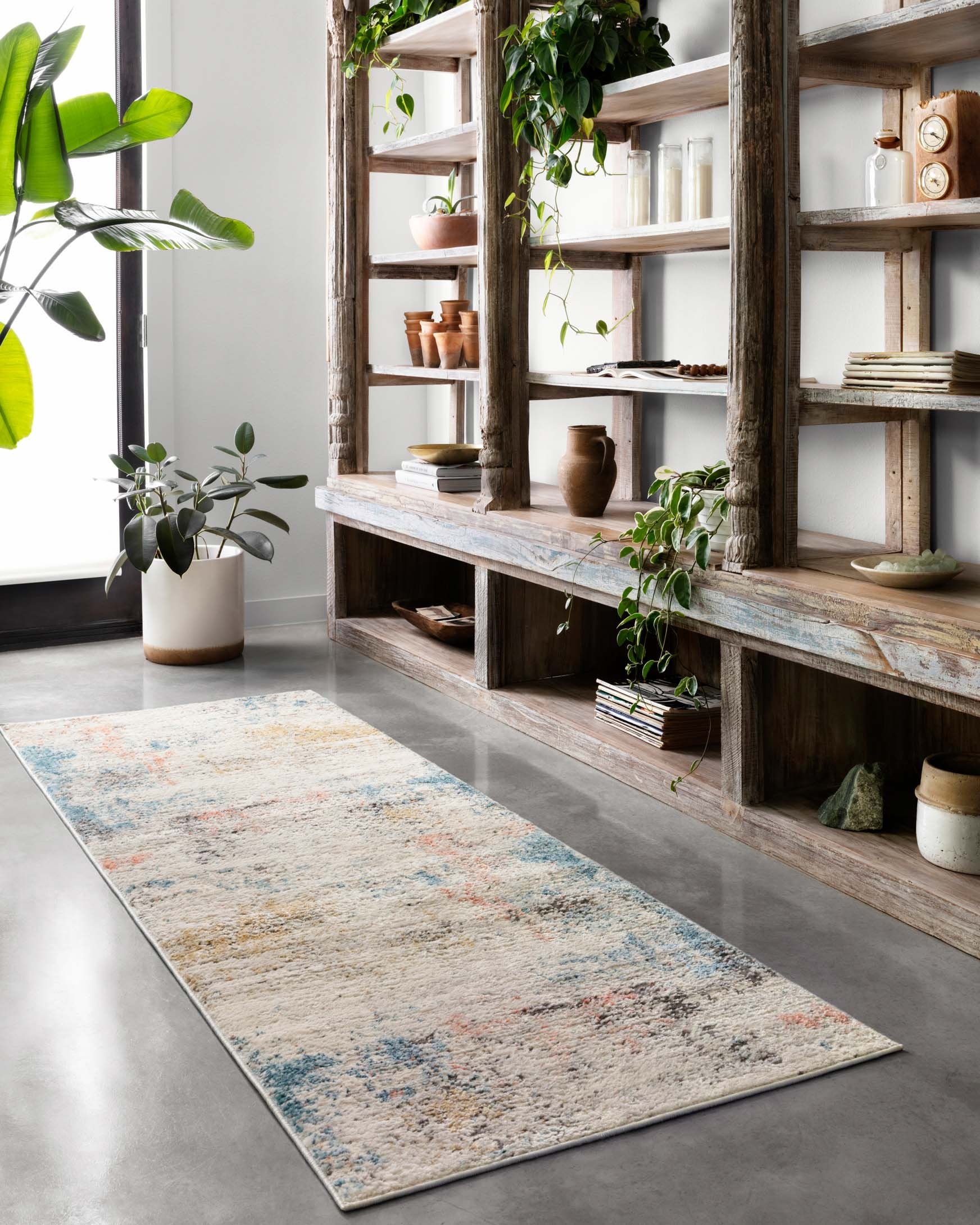 Long ivory rug with distressed multicolor speckle pattern and blue edge trim