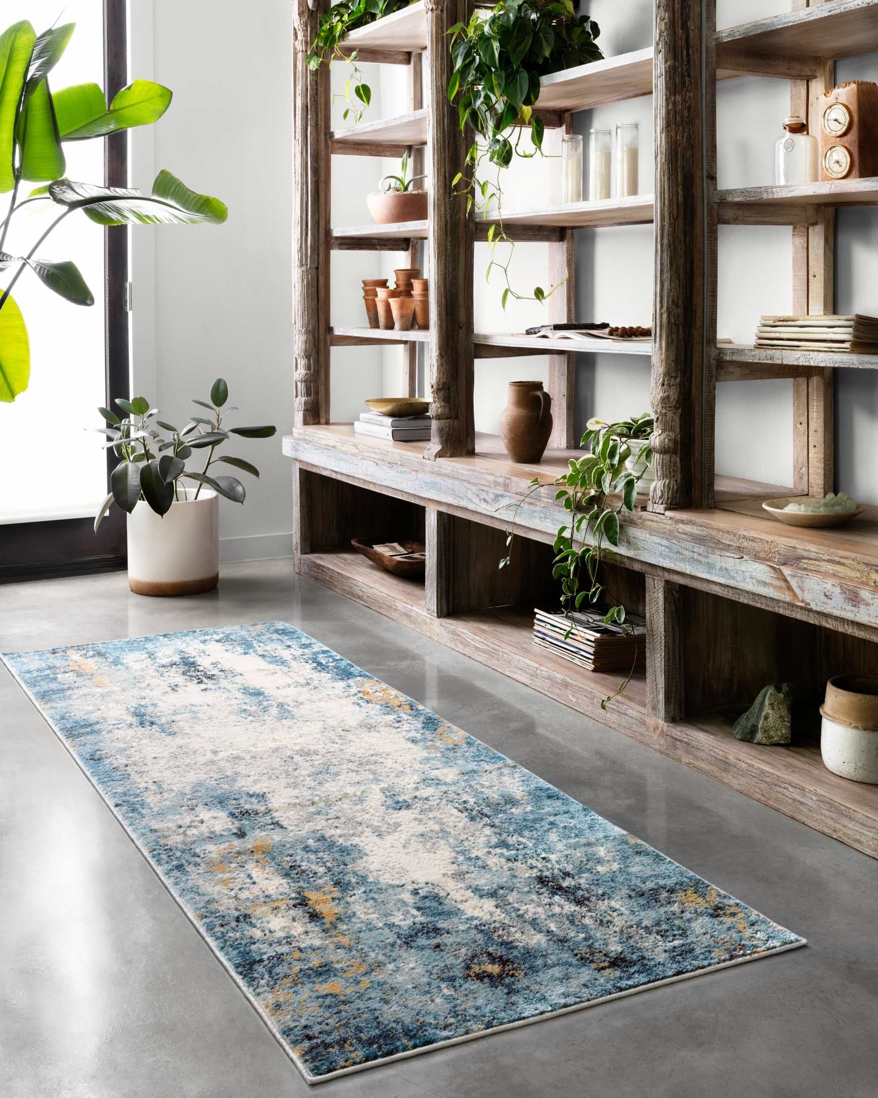 Rectangular runner-style rug in denim blue and ivory with abstract distressed speckling