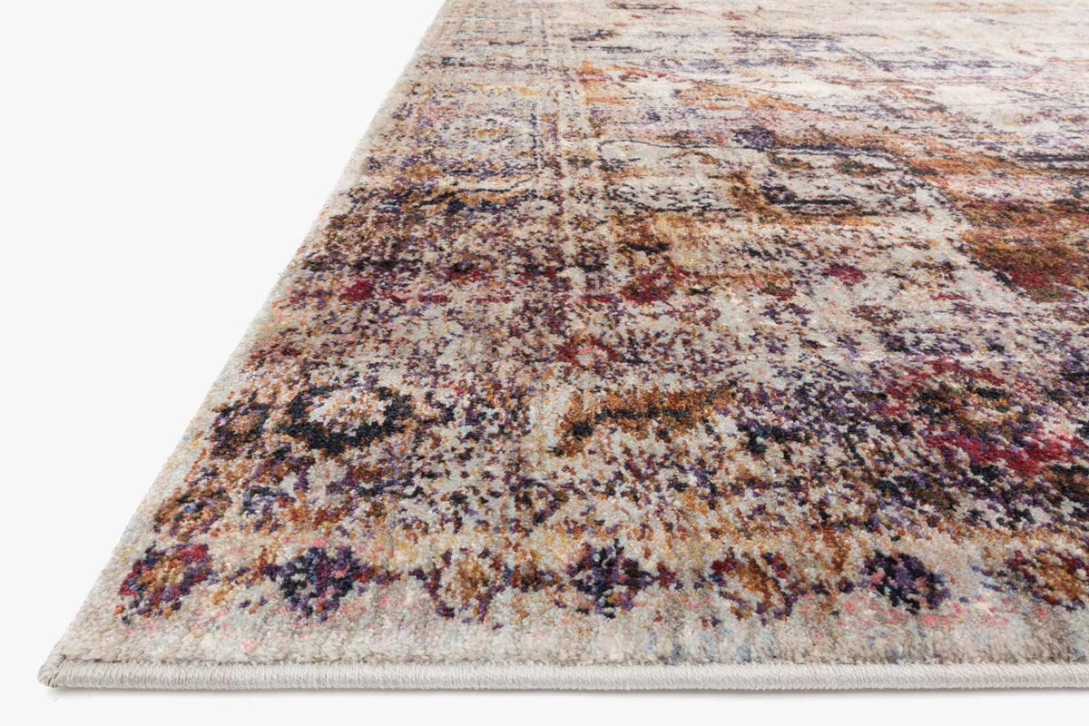Corner close-up of distressed multicolor rug with slate-toned texture and woven edge