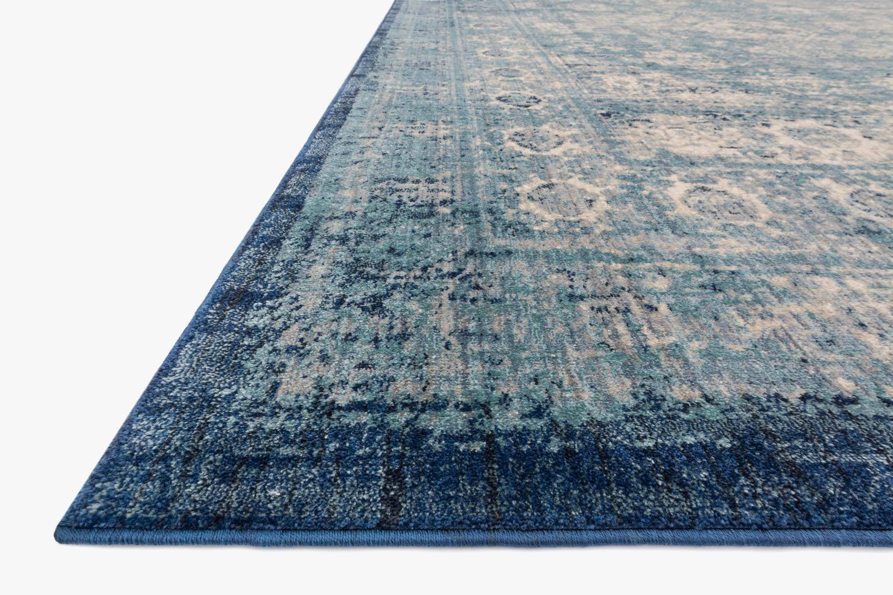 Light blue and ivory rug with distressed border and geometric medallion pattern