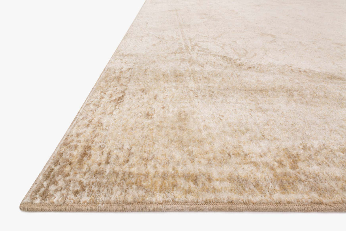 Ivory and light gold rug corner with distressed abstract pile pattern