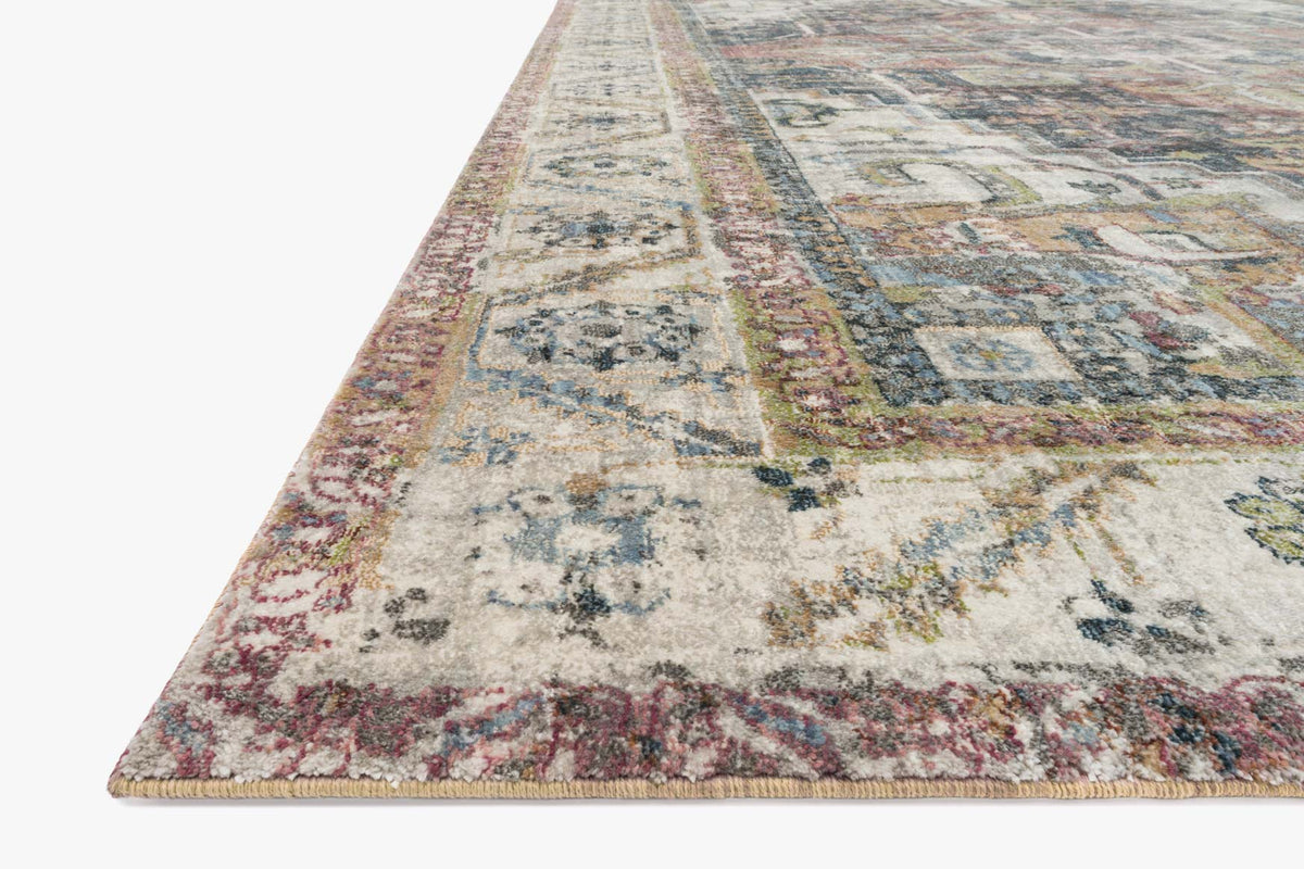Ivory rug with distressed abstract motifs and multicolor patterned border