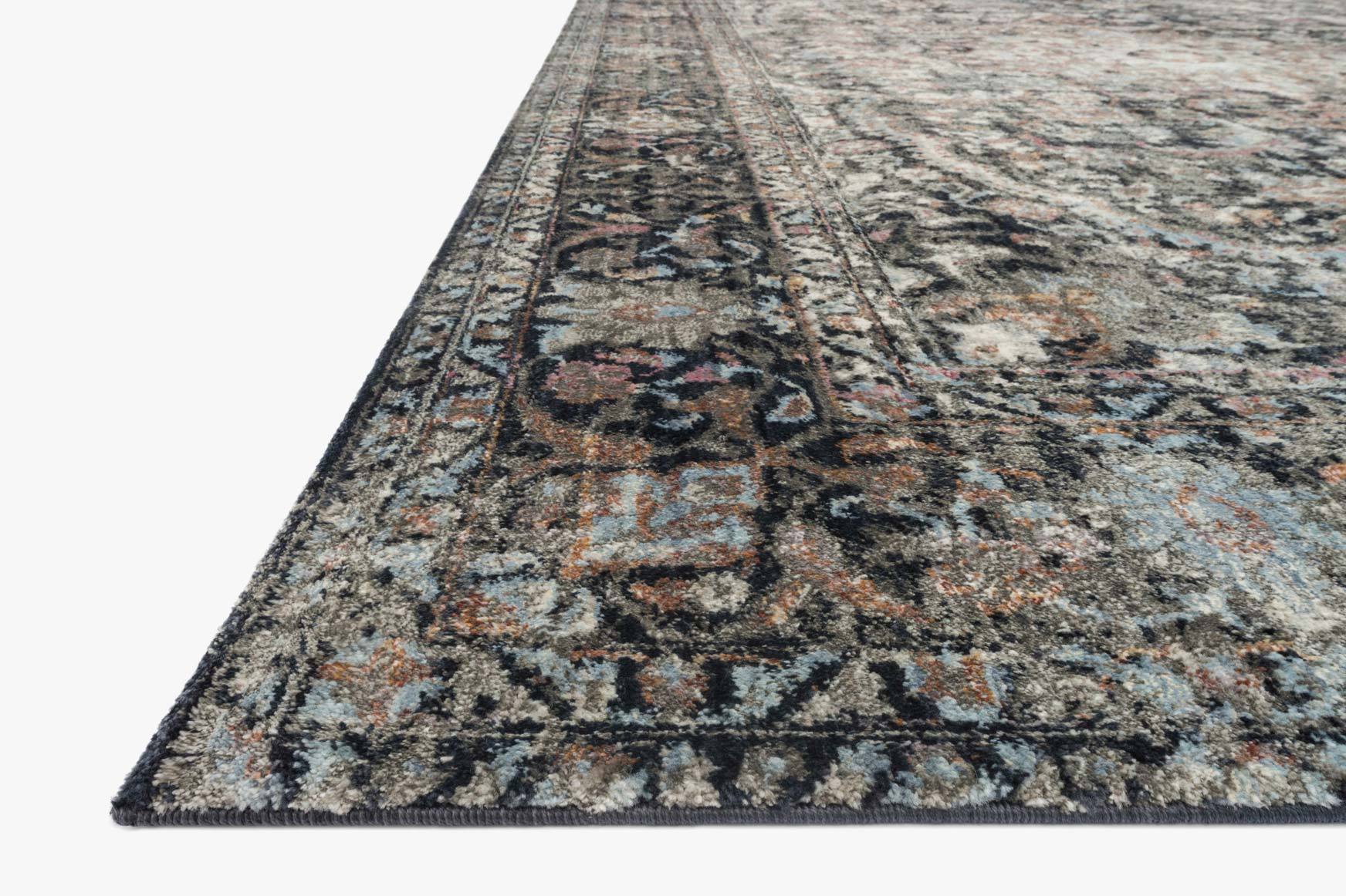 Close-up of charcoal power-loomed rug with distressed abstract motif and border