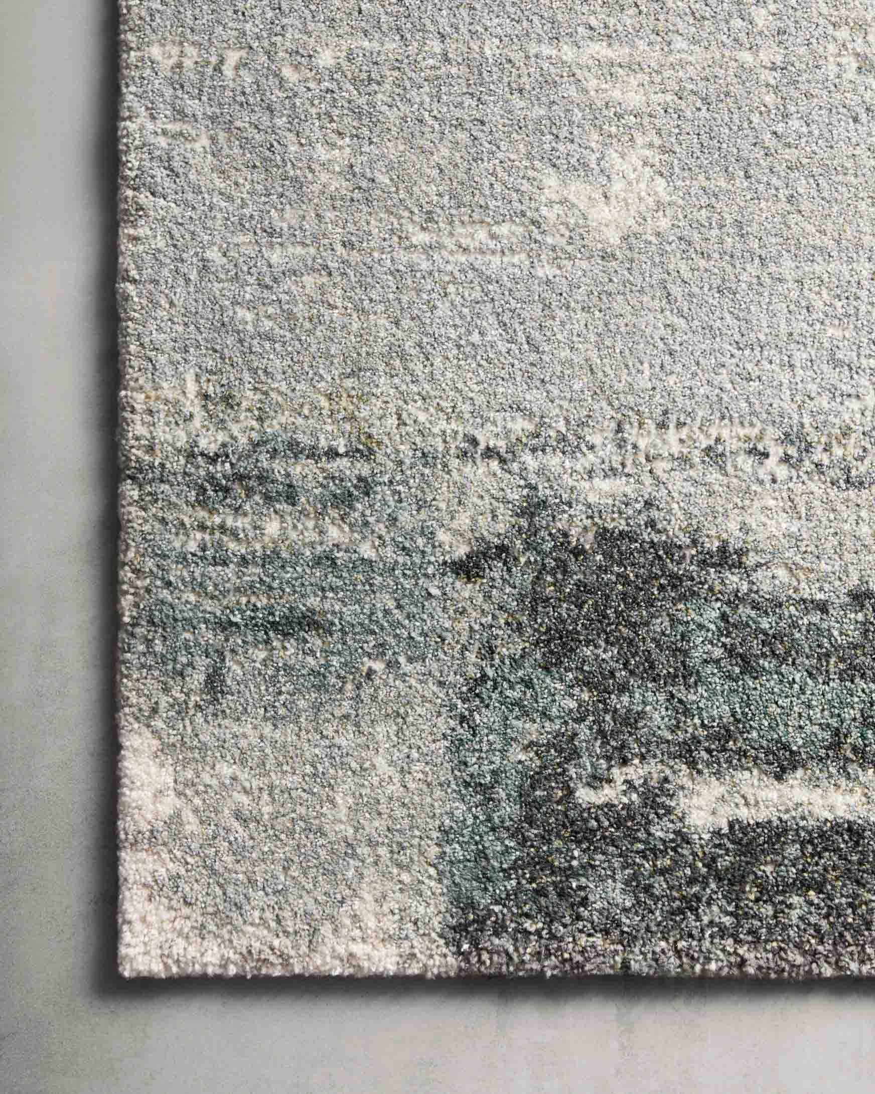 Gray and slate blue textured rug with mottled abstract design
