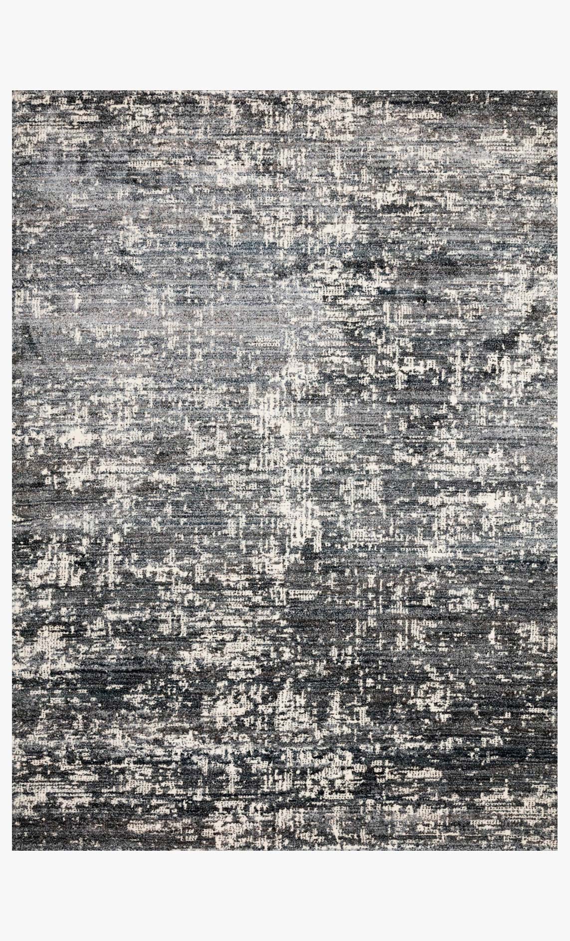 Abstract power-loomed rug with denim blue, gray, and off-white speckled pattern