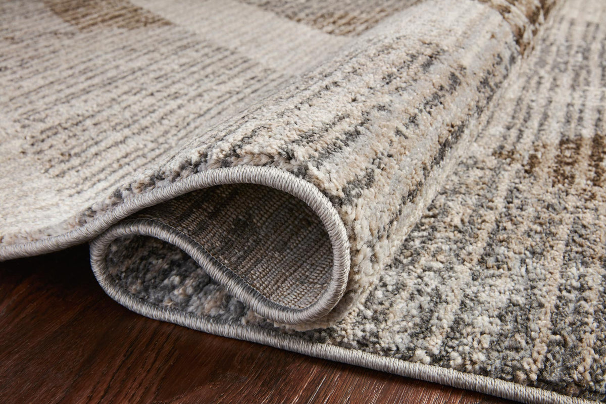 Close-up of rug edge with bound border in stone and bark geometric pattern