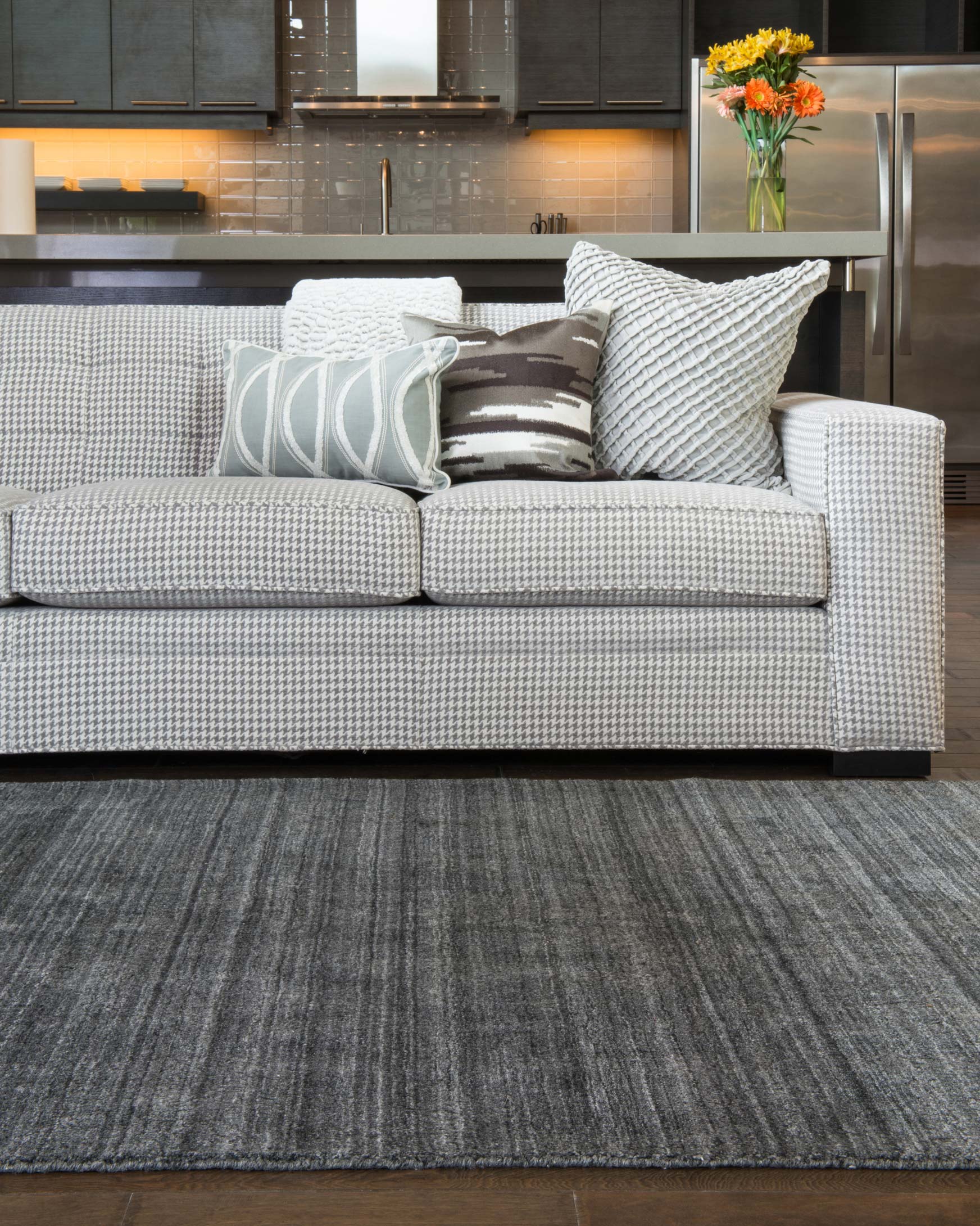Charcoal area rug with subtle linear weave pattern, rectangular