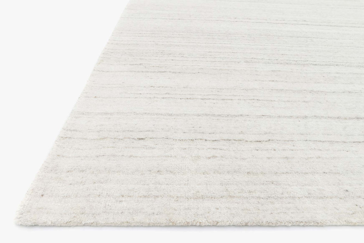 Ivory hand-loomed rug corner view, low pile with fine horizontal striations