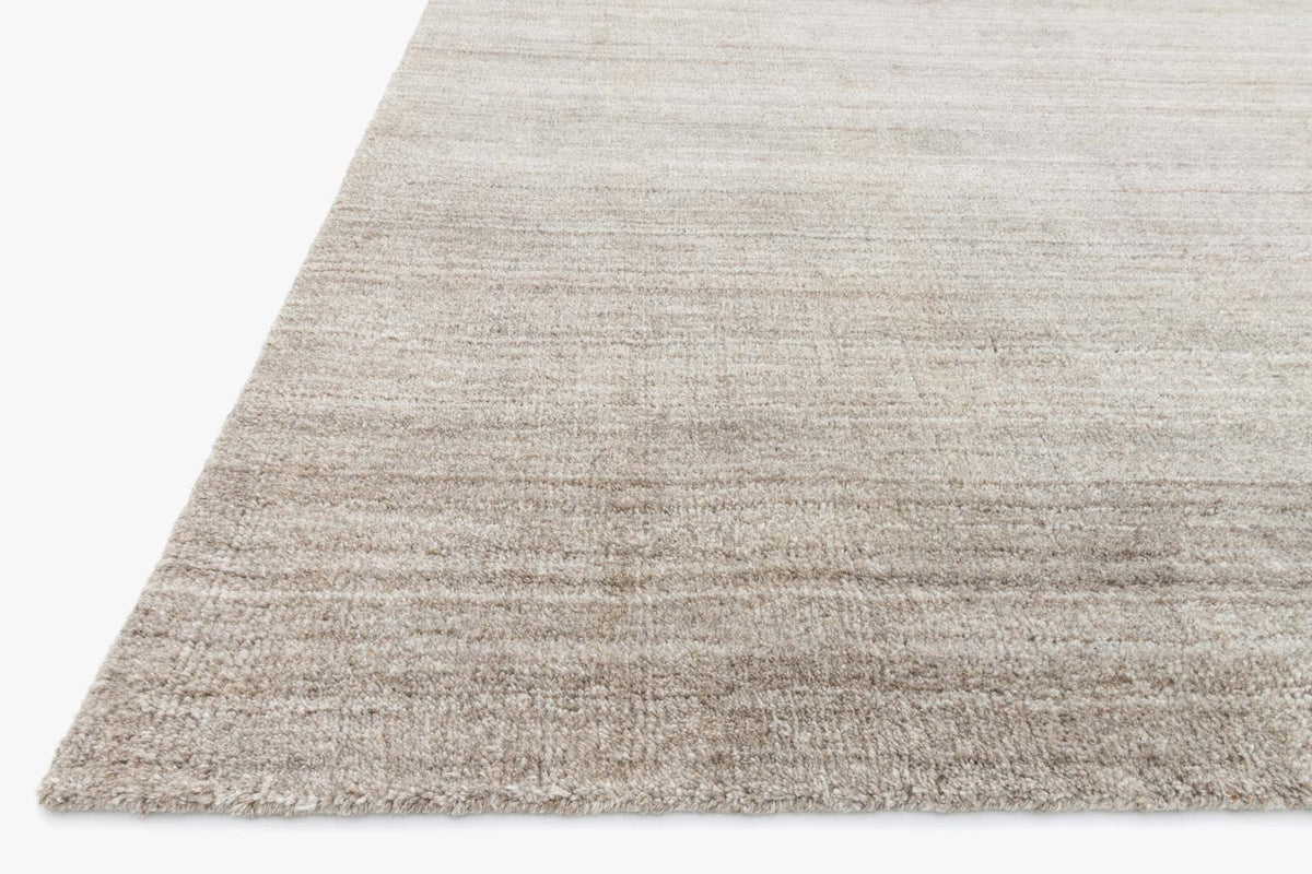 Corner view of hand-loomed transitional rug in light mocha with low-cut textured weave