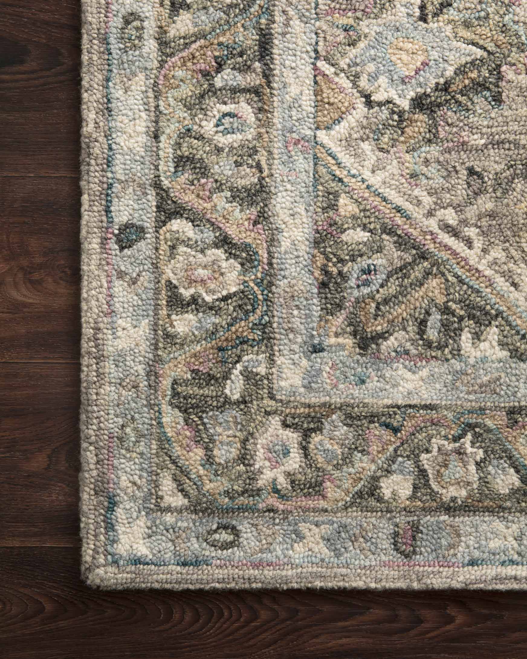 Close-up of sky-blue and beige hooked rug texture with floral and geometric details