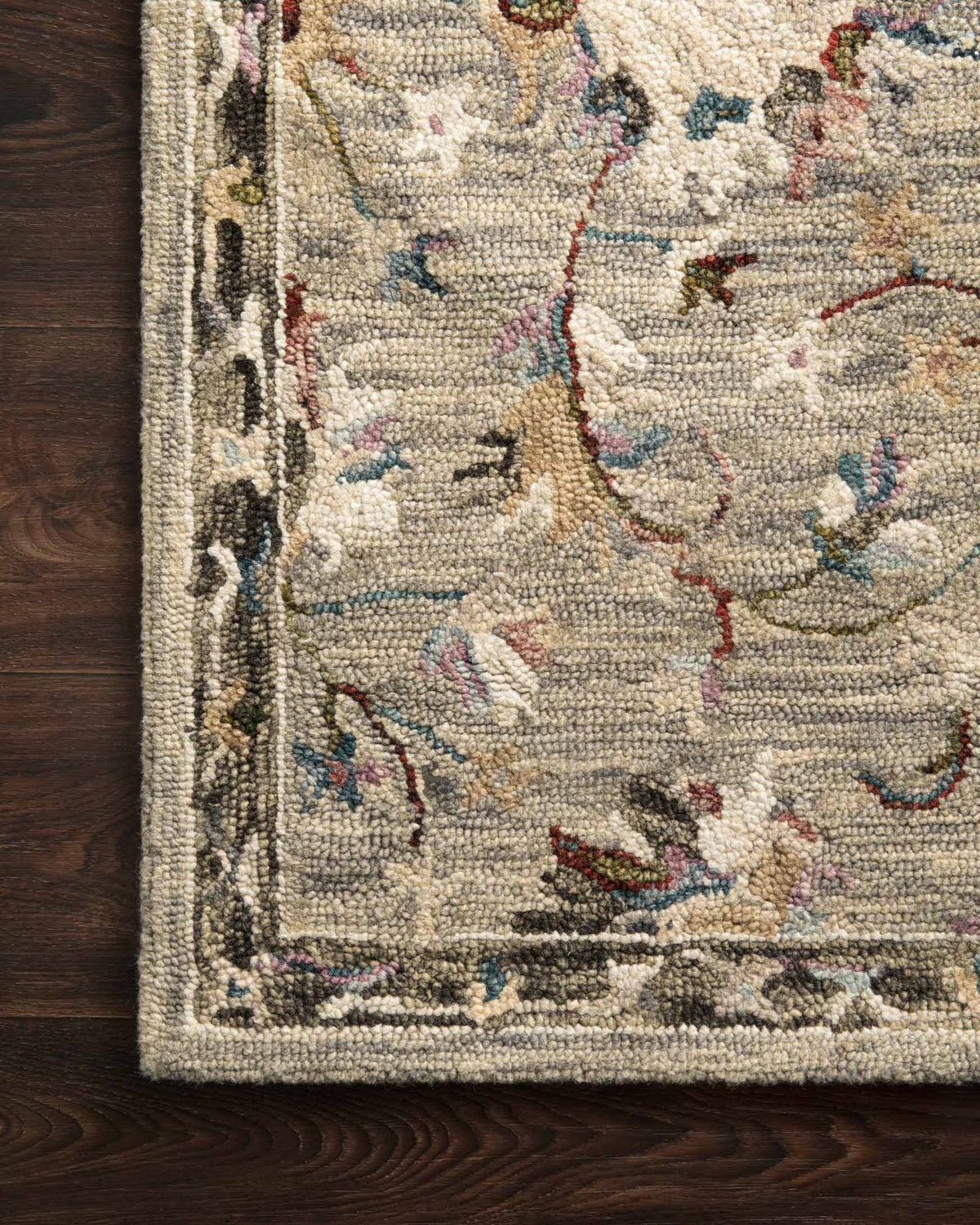 Side edge close-up of traditional hooked rug with multicolor floral texture and trim