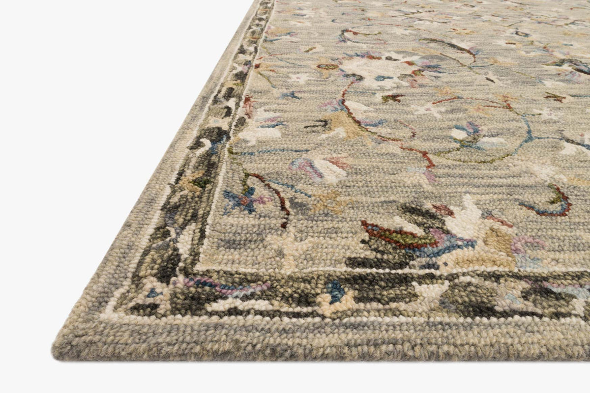 Corner view of traditional hooked rug with multicolor vine pattern and bordered edge