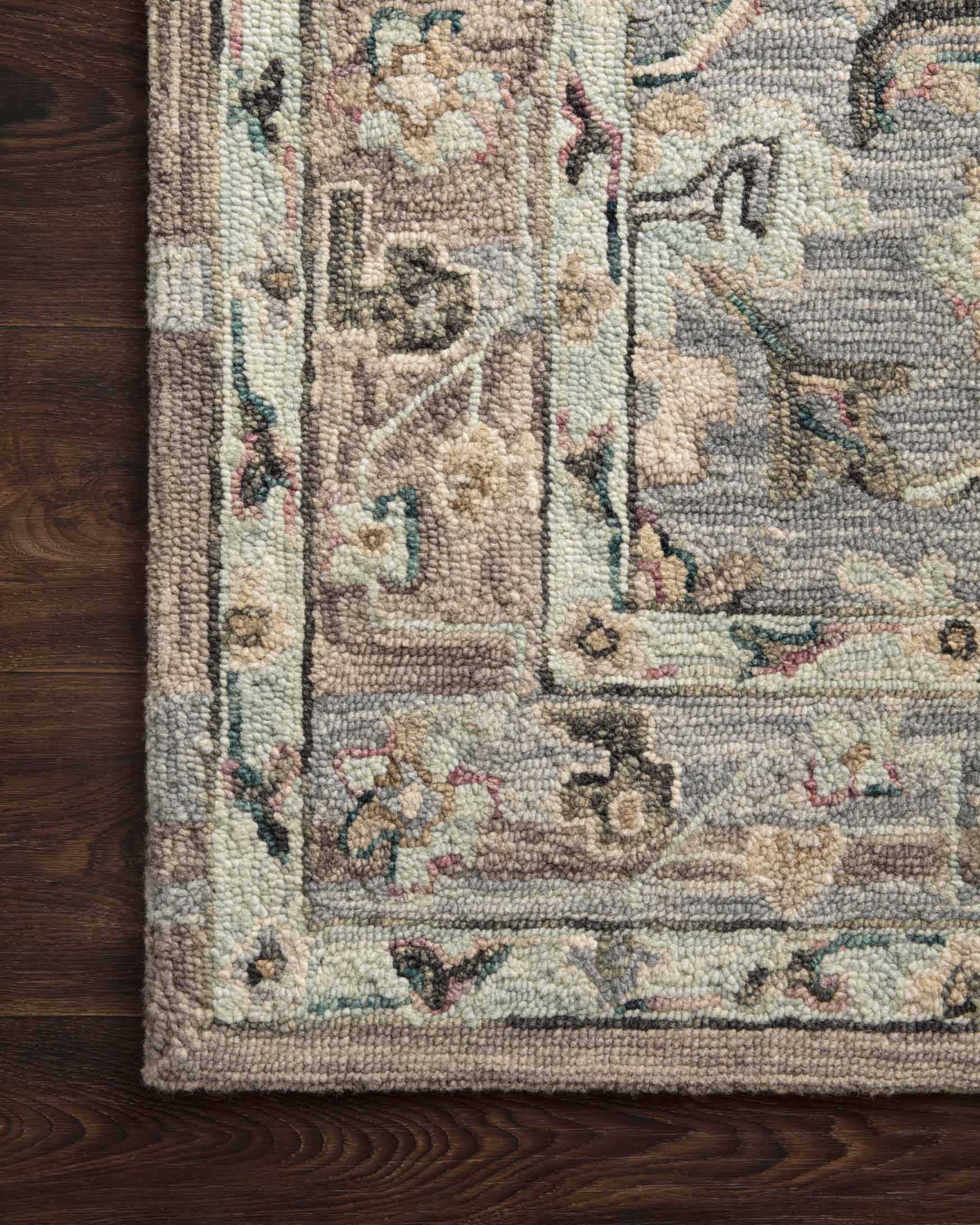 Light blue hooked rug section with distressed multicolor pattern and textured weave