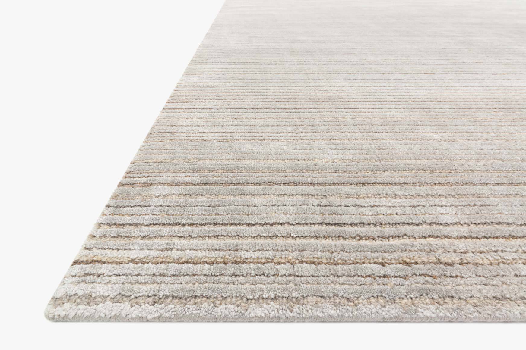 Traditional hand-loomed rug corner view with light blue and beige horizontal stripes