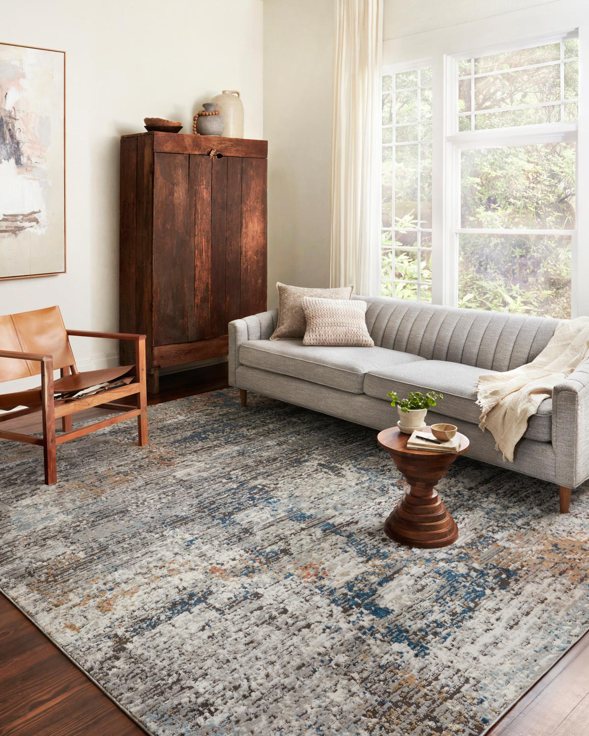 Granite abstract area rug with blue and rust speckled pattern and textured pile.